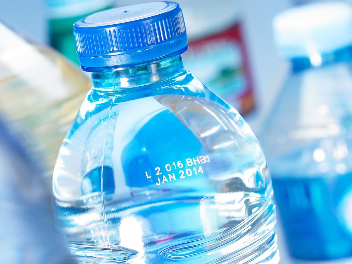 Laser lot and best-before code on a clear PET water bottle